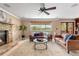 Cozy living room featuring a brick fireplace, leather sofas, and scenic views of the outdoors at 3418 Elk Ct, Broomfield, CO 80020