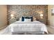 Cozy bedroom with a stone accent wall and bedside tables at 3418 Elk Ct, Broomfield, CO 80020