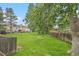 Lush backyard featuring a well-maintained lawn, mature trees, and a wooden fence for added privacy at 9519 W Coal Mine Ave # F, Littleton, CO 80123