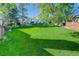 Expansive backyard with a sprawling lawn, mature trees, offering plenty of space for recreation at 9519 W Coal Mine Ave # F, Littleton, CO 80123