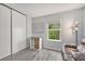 Clean bedroom with neutral walls, laminate flooring, large closet, and natural light at 9519 W Coal Mine Ave # F, Littleton, CO 80123