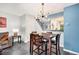 Inviting dining area with modern light fixture, table, and view of the staircase at 9519 W Coal Mine Ave # F, Littleton, CO 80123