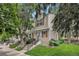 Charming townhome exterior with red shutters, stone accents, and a well-maintained lawn at 9519 W Coal Mine Ave # F, Littleton, CO 80123