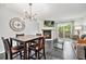 Inviting living and dining area with fireplace, TV, modern chandelier, and access to the deck at 9519 W Coal Mine Ave # F, Littleton, CO 80123