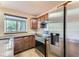 Well-lit kitchen featuring stainless steel appliances, dark countertops, and wood cabinets at 4130 E 94Th Ave # B, Thornton, CO 80229