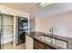 Kitchen island featuring dual basin sink and new washer and dryer at 4130 E 94Th Ave # B, Thornton, CO 80229