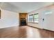 Inviting living room with a cozy fireplace, wood flooring, and ample natural light at 4130 E 94Th Ave # B, Thornton, CO 80229