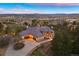 Stunning aerial view of a spacious home with a large driveway, surrounded by trees and overlooking a beautiful landscape at 4605 Tierra Alta Dr, Castle Rock, CO 80104