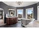 Luxurious bathroom with a freestanding tub, dual vanities, and windows with views at 4605 Tierra Alta Dr, Castle Rock, CO 80104