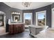 Luxurious bathroom with a soaking tub, elegant fixtures, and scenic views at 4605 Tierra Alta Dr, Castle Rock, CO 80104