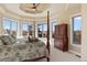Inviting bedroom features a four-poster bed, sitting area with large windows and stunning views, plus a ceiling fan at 4605 Tierra Alta Dr, Castle Rock, CO 80104