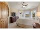 Light-filled bedroom has multiple windows, ceiling fan, closet, and a white color scheme at 4605 Tierra Alta Dr, Castle Rock, CO 80104