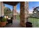Inviting covered patio with stone pillars, comfortable seating and view of lush green lawn at 4605 Tierra Alta Dr, Castle Rock, CO 80104