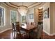 Elegant dining room with chandelier, hardwood floors, and windows offering scenic views at 4605 Tierra Alta Dr, Castle Rock, CO 80104