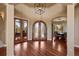 Grand foyer featuring high ceilings, hardwood floors, decorative glass doors and chandelier, leading to the dining room at 4605 Tierra Alta Dr, Castle Rock, CO 80104