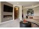 Cozy living room has fireplace, television, comfortable seating, and neutral decor at 4605 Tierra Alta Dr, Castle Rock, CO 80104
