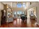 Bright living room with fireplace, piano, hardwood floors and abundant natural light from large windows at 4605 Tierra Alta Dr, Castle Rock, CO 80104