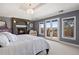 Cozy main bedroom with fireplace, balcony access, and scenic views at 4605 Tierra Alta Dr, Castle Rock, CO 80104