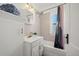Charming bathroom featuring a sink, built-in cabinet, and shower with elegant finishes and natural light at 5008 Sherman St, Denver, CO 80216