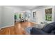Open floor plan with hardwood floors connecting living room to dining area at 5008 Sherman St, Denver, CO 80216