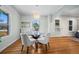 Cozy dining room with a glass table set, stylish chandelier, and hardwood floors at 5008 Sherman St, Denver, CO 80216