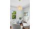 Bright dining area with modern light fixture, neutral color palette, and hardwood floors at 5008 Sherman St, Denver, CO 80216