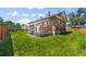 Charming brick home with a covered patio, set against a backdrop of a well-maintained lawn at 5008 Sherman St, Denver, CO 80216