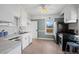 Bright kitchen featuring white cabinets, stainless steel appliances, and a window providing natural light at 5008 Sherman St, Denver, CO 80216