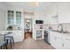 Cozy kitchen boasting white cabinetry, stainless steel appliances, and an adjacent dining area for convenient meals at 5008 Sherman St, Denver, CO 80216