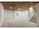 Unfinished basement area with wood ceiling and carpet at 2248 Rosette Ln, Castle Rock, CO 80104
