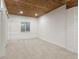 Finished basement displaying a wood plank ceiling, a single window, and bright white shiplap walls at 2248 Rosette Ln, Castle Rock, CO 80104