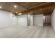 Finished basement showcasing a stylish wood ceiling, neutral carpet, and modern white shiplap walls at 2248 Rosette Ln, Castle Rock, CO 80104