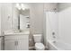 Bathroom with neutral decor offers a bath and shower combination next to the vanity and commode at 2248 Rosette Ln, Castle Rock, CO 80104