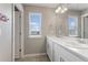 Bathroom with a double vanity, large mirror, and tiled floors at 2248 Rosette Ln, Castle Rock, CO 80104
