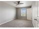 This spare bedroom has soft carpet, a ceiling fan, a good-sized window and access to a closet at 2248 Rosette Ln, Castle Rock, CO 80104