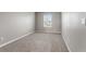 Bedroom with neutral decor, clean carpet, window view, and a light switch at 2248 Rosette Ln, Castle Rock, CO 80104