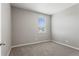 A simple bedroom provides a serene atmosphere with soft carpeting and a view from the bright window at 2248 Rosette Ln, Castle Rock, CO 80104