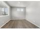 Neutral bedroom featuring wood-look floors and lots of natural light at 2248 Rosette Ln, Castle Rock, CO 80104