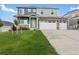 Beautiful two-story home with stone accents, lush lawn, and a three-car garage at 2248 Rosette Ln, Castle Rock, CO 80104