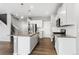 Open kitchen featuring stainless steel appliances, white cabinets, and an island at 2248 Rosette Ln, Castle Rock, CO 80104