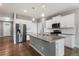 Stylish kitchen with white cabinetry, stainless steel appliances, and center island at 2248 Rosette Ln, Castle Rock, CO 80104