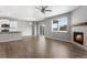 Bright, open-concept living room with modern fireplace, wood floors, and access to the outdoor deck at 2248 Rosette Ln, Castle Rock, CO 80104