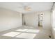 Well-lit bedroom featuring a ceiling fan and access to a bathroom and closet at 2388 W 165Th Pl, Broomfield, CO 80023