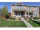 Two-story townhome with landscaped front yard and stone accents at 2388 W 165Th Pl, Broomfield, CO 80023
