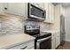 Stainless steel appliances and light-colored cabinetry in this modern kitchen at 2388 W 165Th Pl, Broomfield, CO 80023