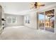 Open living room with fireplace, large windows and access to a deck at 2388 W 165Th Pl, Broomfield, CO 80023