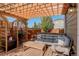 Covered patio with wooden pergola, comfortable seating, and side yard view at 2388 W 165Th Pl, Broomfield, CO 80023