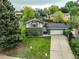 An elevated view of a brick and siding home showing the driveway and surrounding landscape at 9642 Meade Ct, Westminster, CO 80031