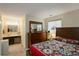 Comfortable bedroom featuring ensuite vanity and natural light from two windows at 9642 Meade Ct, Westminster, CO 80031