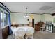 Dining room with white table, adjacent to the kitchen and featuring wood trim at 9642 Meade Ct, Westminster, CO 80031